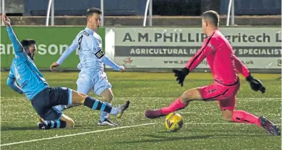  ??  ?? Cove’s Mitch Megginson beats a Forfar defender and goalkeeper to the ball to net the winner