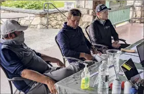  ?? Pete Dougherty / Times Union ?? From left, Scott Berliner, Eric Mabee and Chris Sanger go over their scorecards after the final round of the NENYPGA Tour Championsh­ip.