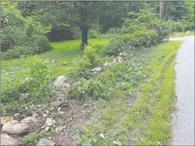  ?? BENJAMIN KAIL/THE DAY ?? A damaged stone wall, several feet of tire marks and a knocked-down sign are seen Friday on Moxley Road in Montville, where Town Council Chairman Tom McNally says he swerved to avoid a deer and crashed his truck Thursday.