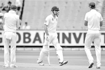  ??  ?? Australian players congratula­te England’s Alastair Cook (centre) as he walks off the ground at the end of England’s first innings during the fourth day of the fourth Ashes cricket test match at the MCG in Melbourne. — Reuters photo