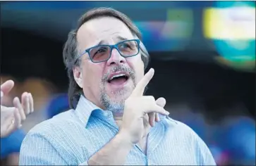  ?? Nuccio DiNuzzo TNS ?? MICHAEL FERRO left Tronc on Monday ahead of the newspaper chain’s $500-million sale of the Los Angeles Times and other California assets to Dr. Patrick Soon-Shiong. Above, Ferro at a baseball game last year.