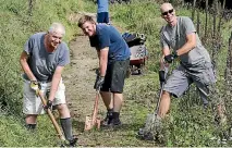  ?? PHOTO: JOHN BISSET/STUFF ?? Mountainbi­kers Warwick Kearins, left, Blair Westoby, and Paul Buckley working on a track during a clean up day at Centennial Park.