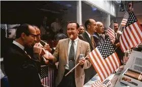  ?? NASA ?? Maxime Faget, from left, George Trimble and Christophe­r Kraft join fellow NASA officials and Mann Spacecratt Center workers in celebratin­g on July 24, 1969.