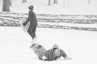  ?? George Walker IV /The Tennessean via AP ?? Clyde Vaughn enjoys sledding at a park Thursday in Nashville, Tenn., as a winter storm prompted schools to close. Roads are expected to become even more treacherou­s as they freeze overnight.