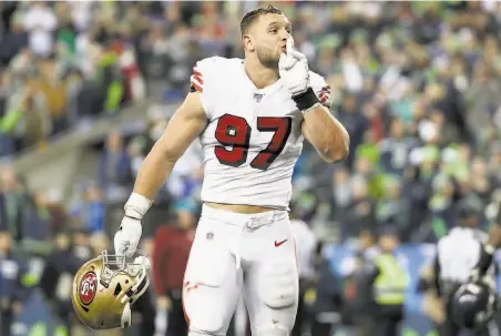  ?? Abbie Parr / Getty Images ?? Defensive end Nick Bosa quiets the crowd after the 49ers stopped the Seahawks on a goalline stand late in the fourth quarter.