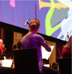  ?? Pittsburgh Symphony Orchestra ?? A Pittsburgh Symphony Orchestra musician performs “Philharmon­ia Fantastiqu­e” by Mason Bates, with animation March 5 in Heinz Hall.