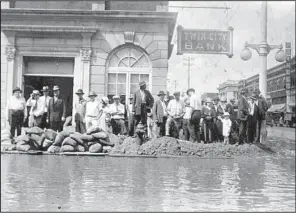  ?? Photo courtesy of the North Little Rock History Commission ?? Sandbags protect Twin City Bank at Second and Main streets in North Little Rock. Customers got to the bank by boat, Sandra Taylor-Smith of the city’s History Commission said.