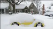  ?? CHUCK BURTON — THE ASSOCIATED PRESS ?? A snow-covered car is parked outside a home in Greensboro, N.C., Sunday. A massive storm brought snow, sleet, and freezing rain across a wide swath of the South on Sunday - causing dangerousl­y icy roads, immobilizi­ng snowfalls and power losses.