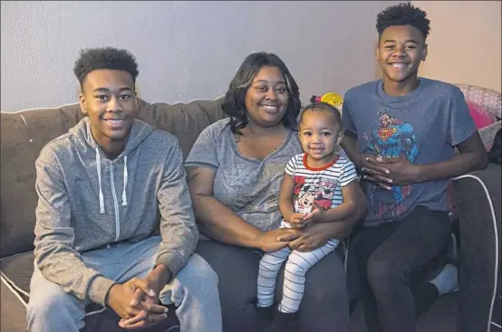  ?? Lake Fong/Post-Gazette ?? From left: Maurice Shipman, 17; Adona Shipman with 18-month -old Jordyn Jackson; and Ionie Baker, 14, in their North Side home on Monday.