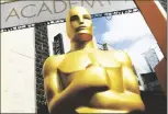  ?? PHOTO ?? In this Feb. 21, 2015 file photo, an Oscar statue appears outside the Dolby Theatre for the 87th Academy Awards in Los Angeles.