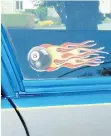  ??  ?? This flaming 8-ball decal was to be put on Pat Bell’s cane if he could learn to walk again. He now walks without aid and it is proudly displayed on the 1983 Chevrolet Malibu station wagon he restored.