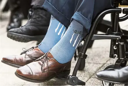  ??  ?? Fashion statement: Bush wearing socks depicting military jets flying in formation during a Pearl Harbour remembranc­e ceremony at the George Bush Presidenti­al Library in College Station, Texas, in 2016. — AP