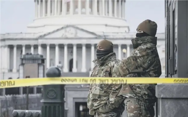  ??  ?? 0 National Guard troops stand watch at the US Capitol following the storming of the building by Trump supporters which led to five deaths, including a policeman