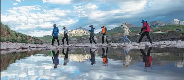  ?? ?? The scientific expedition team of the Changjiang River Scientific Research Institute conducts research in Zadoi county, Qinghai province, in the source area of the Lancang River.