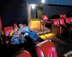  ?? CHRIS SWEDA/CHICAGO TRIBUNE ?? Patricia and Lorenzo Fuller watch “Godzilla vs. Kong” at the AMC Ford City 14 movie theater April 16 on Chicago’s Southwest Side.