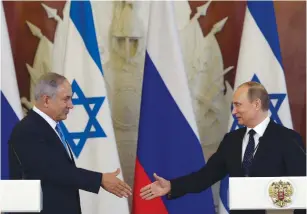  ?? (Haim Zach/GPO) ?? PRIME MINISTER Benjamin Netanyahu and Russian President Vladimir Putin shake hands at a joint press conference yesterday in the Kremlin.