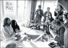 ?? GETTY ?? In this file photo taken March 25, 1969, John Lennon and his wife, Yoko Ono, receive journalist­s in the bedroom of the Hilton hotel in Amsterdam, during their honeymoon in Europe.
