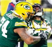  ??  ?? Former Mississipp­i State player Elgton Jenkins, left, of the Green Bay Packers celebrates with Aaron Jones after a touchdown against the Los Angeles Rams on Saturday. (Photo by Mike Roemer, AP)