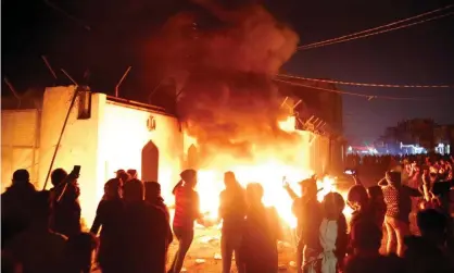  ?? Photograph: Stringer/Reuters ?? Demonstrat­ors torch the Iranian consulate as they gather during escalating anti-government protests in Najaf, Iraq.