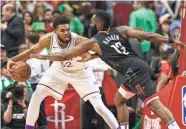  ??  ?? Timberwolv­es center Karl-anthony Towns controls the ball as Rockets guard James Harden (13) defends. TROY TAORMINA/USA TODAY SPORTS