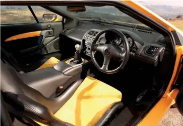  ??  ?? Clockwise from left: Alcantara racing seats liven up the interior, while the air-con has been removed; Spice Yellow paint looks the business; it’s hard to relax with pin-sharp steering and two turbos sucking and blowing