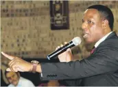  ??  ?? Local clergyman John Mokoena attempts to calm down disgruntle­d residents at the Ward 20 community meeting.