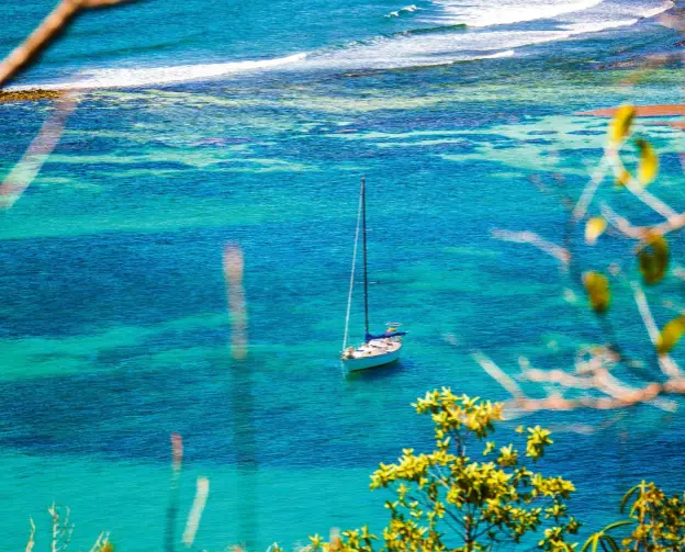  ??  ?? Top: Elixir anchored off Isle à Quatre. Above: off uninhabite­d Petit Nevis.