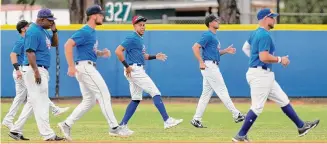  ?? Wilfredo Lee/Associated Press ?? Players for the Cuban Profession­al Baseball Federation warm up for an exhibition baseball game against Miami Dade College on Wednesday. The team is a group of about 30 or so players, most of whom were born in Cuba and defected from their home island.