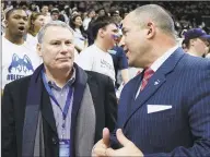  ?? Jessica Hill / Associated Press ?? AAC commission­er Mike Aresco, left, talks with UConn athletic director David Benedict, right, before a basketball game between UConn and South Carolina in Storrs in 2017.