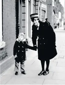  ??  ?? Warden Jack Oldham and (right) a lost child is assisted by colleague Pat Coward. Below, helping to keep Burton moving