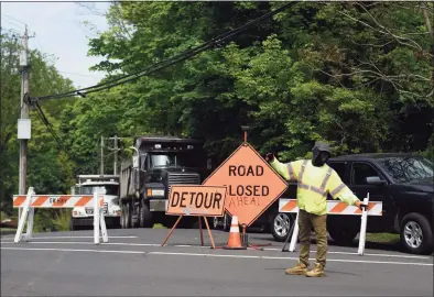  ?? Hearst Connecticu­t Media file photo ?? Traffic was redirected when Anderson Road was closed in Greenwich on May 19 as crews repaired damage from a water main break. Another water main break occurred on the same road on Monday morning.