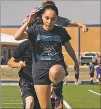  ?? Arcenio J. Trujillo ?? Outside, and on the multi-purpose field for the first half of her dual practices, Questa junior Christina Cisneros runs through a bevy of warm-up drills with the soccer team Aug. 20. Cisneros is a multisport athlete and spends the second half of her afternoon workout routine inside the gym with the volleyball team.