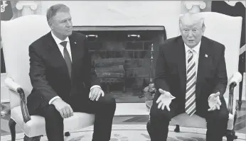  ?? Tribune News Service ?? President Donald Trump, right, speaks as Klaus Iohannis, Romania’s president, listens during a meeting in the Oval Office of the White House in Washington, D.C., U.S., on Tuesday, Aug. 20.