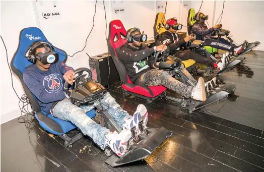  ??  ?? WHEEL DEAL: Gamers at VR World, one of at least seven virtual reality centers that have cropped up in New York in the past two years.