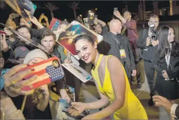  ?? Jay L. Clendenin Los Angeles Times ?? GAL GADOT takes time out for her fans before making her way to the Palm Springs festival gala on Tuesday.