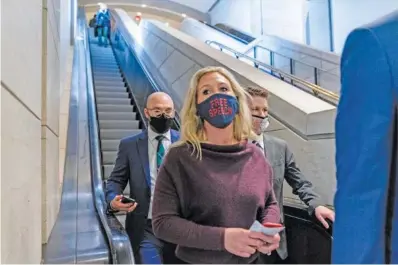  ?? AP PHOTO/ANDREW HARNIK ?? Rep. Marjorie Taylor Greene, R-Ga., goes back to her office after speaking on the floor of the House Chamber on Capitol Hill in Washington on Thursday.