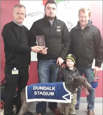  ??  ?? Ciaran O’Neill and connection­s of Ocean Queen receive the trophy from Dermot Mulholland following her win in the Racecourse Road S7 - S10 400 final.