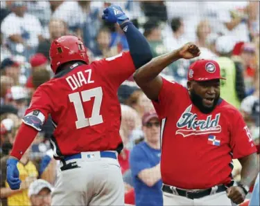  ?? ALEX BRANDON — THE ASSOCIATED PRESS ?? The World team’s Yusniel Diaz, of the Los Angles Dodgers, celebrates his home run with World manager David Ortiz in the seventh inning of the All-Star Futures game July 15 in Washington.