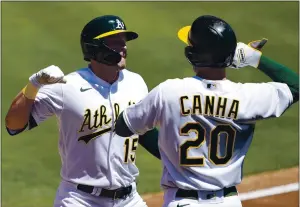  ?? TONY AVELAR — THE ASSOCIATED PRESS ?? The Athletics’ Seth Brown (15) is congratula­ted by Mark Canha after hitting a two-run home run.