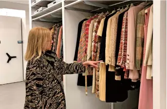  ??  ?? Director and curator Valerie Steele gestures during a tour of the permanent archives at the Fashion Institute of Technology in New York. The outfits are stored in one of two climate-controlled rooms that house more than 50,000 items. — IC