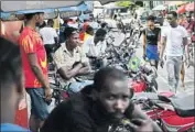  ?? Matias Delacroix Associated Press ?? TAXI drivers on motorcycle­s wait for fares in Portau-Prince as Haitians begin to come out from hiding.