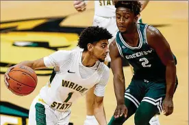  ?? E.L. HUBBARD / CONTRIBUTE­D ?? Wright State guard Trey Calvin and his teammates are in good handswith Scott Nagy as their coach, the school’s athletic director, Bob Grant, says.
