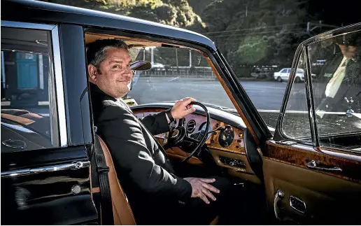 ?? ROSA WOODS/STUFF ?? Gavin Murphy, general manager at Gee & Hickton Funeral Directors, at the wheel of a 1970 Rolls Royce Phantom VI hearse which was once used to carry royalty.