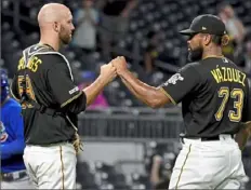  ?? Matt Freed/ Post- Gazette ?? Felipe Vazquez celebrates with catcher Jacob Stallings after recording a save against the Cubs July 2 at PNC Park.