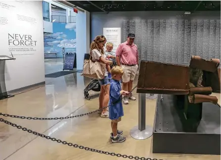  ?? Leslie Plaza Johnson / Contributo­r ?? Kelly and David Leonard and their children Dee and Richard visit the exhibit “Never Forget: Commemorat­ing the 20th Anniversar­y of 9/11” at the Lone Star Flight Museum. Museum leaders wanted the milestone anniversar­y to be memorializ­ed.