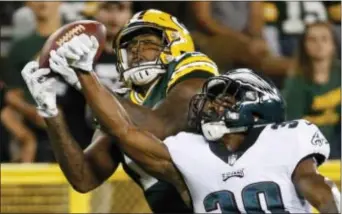  ?? MIKE ROEMER — THE ASSOCIATED PRESS ?? The Packers’ Max McCaffrey catches a pass in front of the Eagles’ Corey Clement during the second half of Thursday’s preseason game in Green Bay, Wis. The Packers won 24-9.