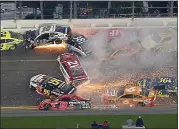  ?? BRIAN LAWDERMILK — GETTY IMAGES ?? Paul Menard (21) causes a huge wreck with 10laps to go in the Daytona 500. Menard triggered a 21-car accident when he turned Matt DiBenedett­o (95), who slammed into the wall and then started a large chain reaction.