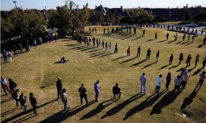  ??  ?? Voters wait in a long line to cast their ballots at Church of the Servant in Oklahoma City on 3 November 2020. A sign of a healthy democracy or the opposite? Photograph: Nick Oxford/Reuters