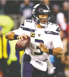  ?? Rob Carr/ Getty Images ?? Seattle quarterbac­k Russell Wilson has a knack of extending the play, Green Bay DC Mike Pettine says.