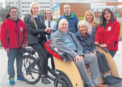  ??  ?? Mr Ridley, seated, has teamed up with his local school and council for a Cycling Without Age project which he hopes will get older people out and about.